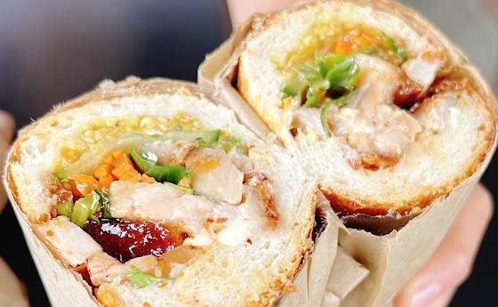 BBQ pork banh mi cut in half on sourdough